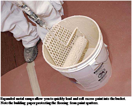 Подпись: Expanded metal ramps allow you to quickly load and roll excess paint into the bucket. Note the building paper protecting the flooring from paint spatters. 