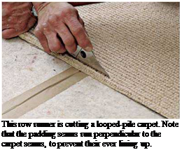 Подпись: This row runner is cutting a looped-pile carpet. Note that the padding seams run perpendicular to the carpet seams, to prevent their ever lining up. 