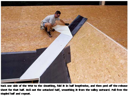 Подпись: Tack one side of the WSU to the sheathing, fold it in half lengthwise, and then peel off the release sheet for that half. Roll out the untacked half, smoothing it from the valley outward. Pull free the stapled half and repeat. 