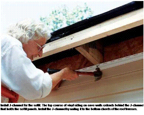 Подпись: Install J-channel for the soffit. The top course of vinyl siding on eave walls extends behind the J-channel that holds the soffit panels. Install the J-channel by nailing it to the bottom chords of the roof trusses. 