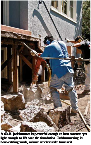 Подпись: A 60-lb. jackhammer is powerful enough to bust concrete yet light enough to lift onto the foundation. Jackhammering is bone-rattling work, so have workers take turns at it. 