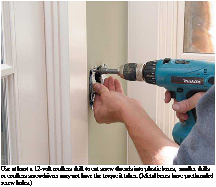Подпись: Use at least a 12-volt cordless drill to cut screw threads into plastic boxes; smaller drills or cordless screwdrivers may not have the torque it takes. (Metal boxes have prethreaded screw holes.) 